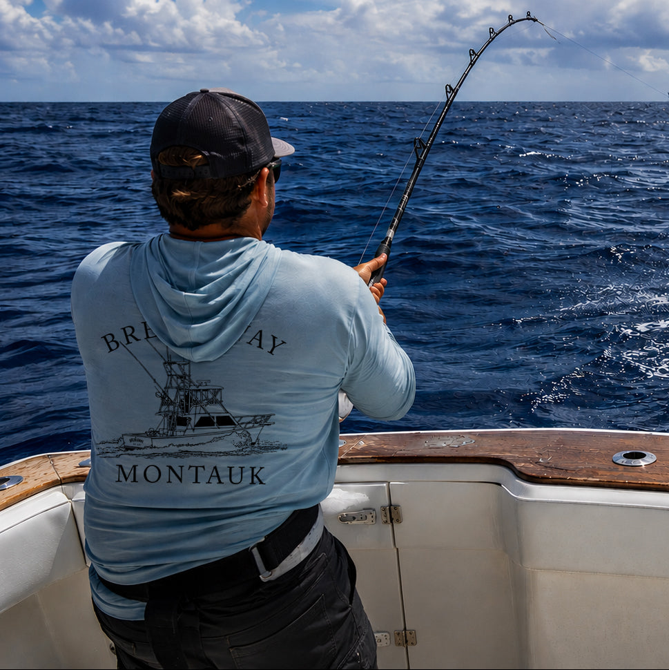 Man on a boat fishing with a large fish jumping out of the water.